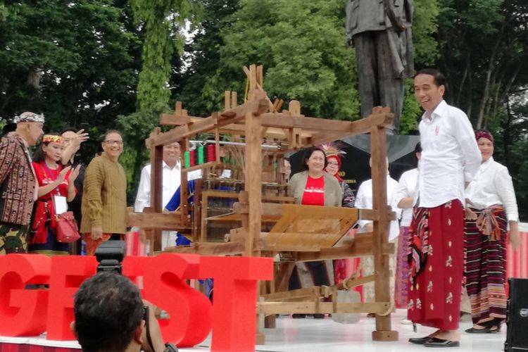 Presiden Joko Widodo mengamati alat tenun bukan mesin (ATBM) di Festival Sarung Indonesia 2018, Plaza Tenggara, Gelora Bung Karno, Jakarta, Minggu (3/3/2019).