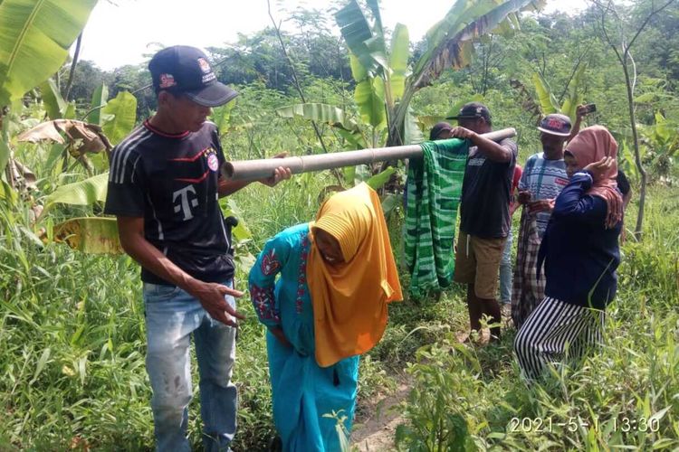 Enah (39) harus ditandu ke Puskesmas Sindangresmi, Kabupaten Pandeglang saat hendak melahirkan lantaran akses jalan ke rumahnya tidak bisa dilalui kendaraan roda empat, Sabtu (1/5/2021).