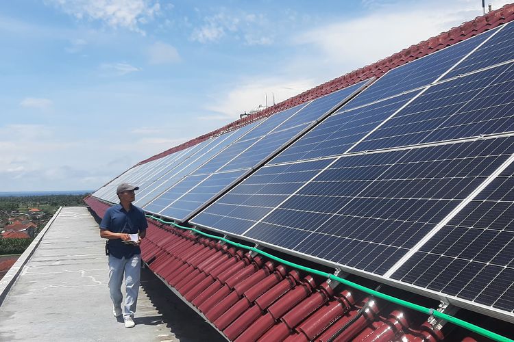 Seorang staf memeriksa kondisi panel surya di atap Hotel Santika Banyuwangi, yang berlokasi di Kelurahan Sobo, Kecamatan/Kabupaten Banyuwangi, yang mulai memanfaatkan energi baru terbarukan, Rabu (28/12/2022).