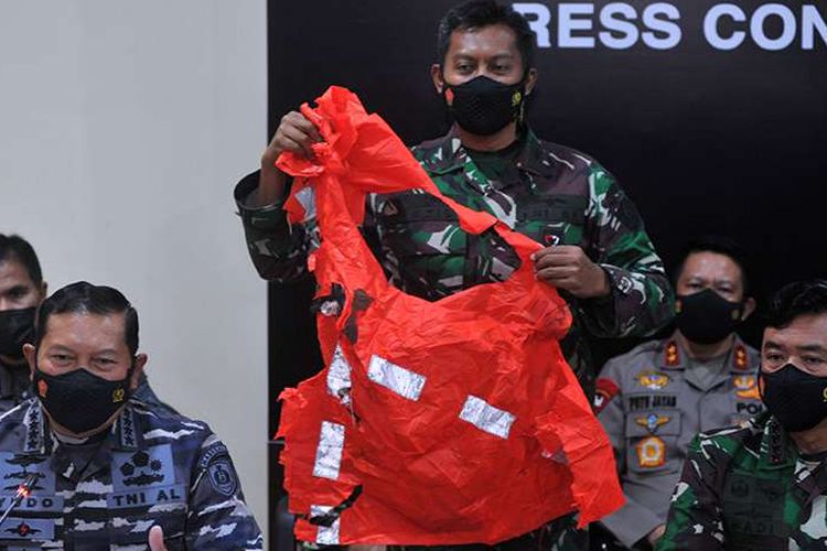 Indonesia Military (TNI) commander Air Chief Marshal Hadi Tjahjanto (right) and Navy chief of staff Admiral Yudo Margono (left) showing an escape suit in orange color belongs to the sailors of KRI Nanggala 402 submarine during a press conference in Bali, Sunday, April 25, 2021. 