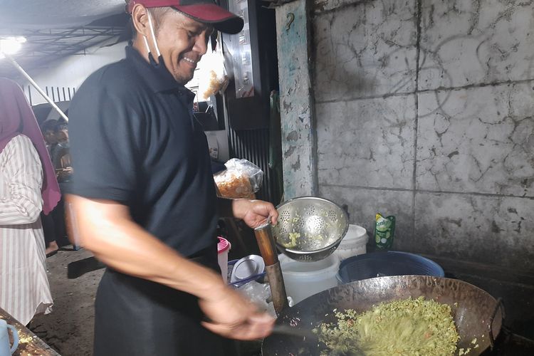 Mujianto saat membuat nasi goreng pelangi