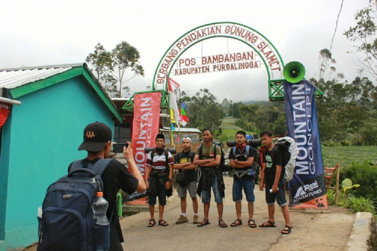 Para pendaki berfoto di bawah gerbang gapura sebelum memulai pendakian Gunung Slamet via basecamp Bambangan, Purbalingga, Jawa Tengah, Rabu (16/8/2017).