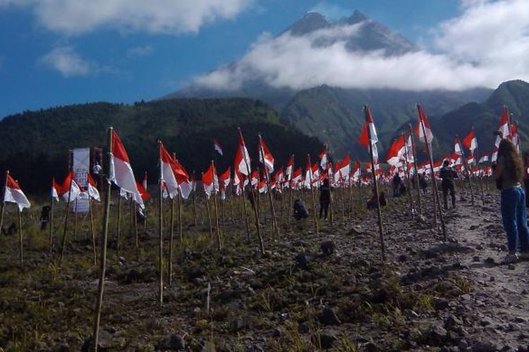 Raising 1000 red and white flags when celebration of Indonesian Independence Day at Kaliadem, Cangkringan, Yogyakarta, Indonesia with view of Merapi Mountain on Sunday, August 17, 2014.