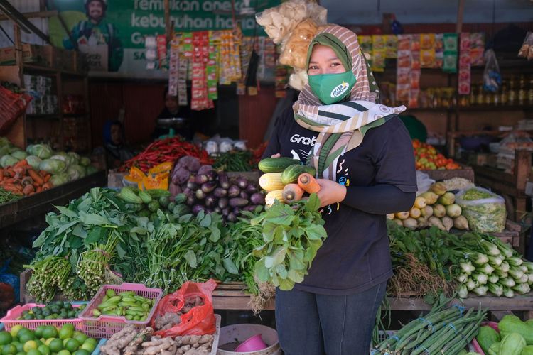 Rhina, pedagang sayur di  Pasar Tradisional Hartaco, Parang Tambung, Kota Makassar. Thina masih berusia 24 tahun. Meski amsih muda, ia sukses menaikkan omzet hingga lima kali lipat dengan memanfaatkan platform digital GrabMart.