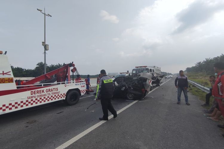 Petugas kepolisian saat melakukan olah TKP pada kasus kecelakaan lalu lintas yang menewaskan dua orang korban di jalan tol Pekanbaru-Dumai, Sabtu (4/11/2023).