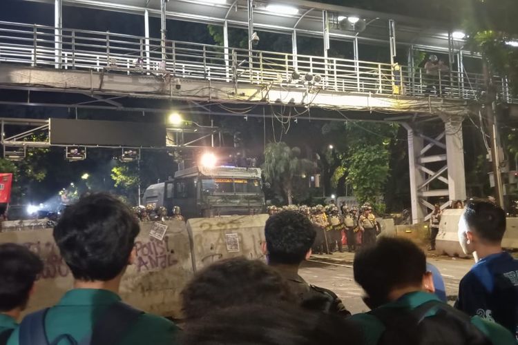 Polisi memarkir mobil water cannon untuk mengintimidasi mahasiswa dari aliansi BEM Seluruh Indonesia (SI) karena tidak kunjung menyelesaikan aksi unjuk rasa mereka di samping Patung Arjuna Wijaya, Gambir, Jakarta Pusat, Jumat (27/12/2024). 