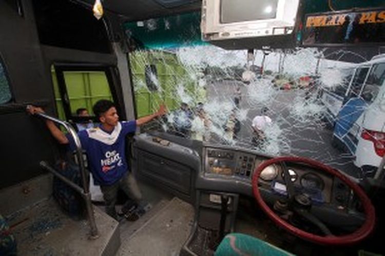 Suporter Persib Bandung melihat keadaan dalam bus Tim Persib Bandung di Rest Area KM 19 Tol Cikampek, Jawa Barat, Minggu (22/6/2013). Rombongan Tim Persib yang sedianya akan bertanding melawan tuan rumah Persija Jakarta diserang oleh oknum suporter Persija ketika keluar dari hotel di kawasan Jalan Gatot Subroto, Jakarta. 