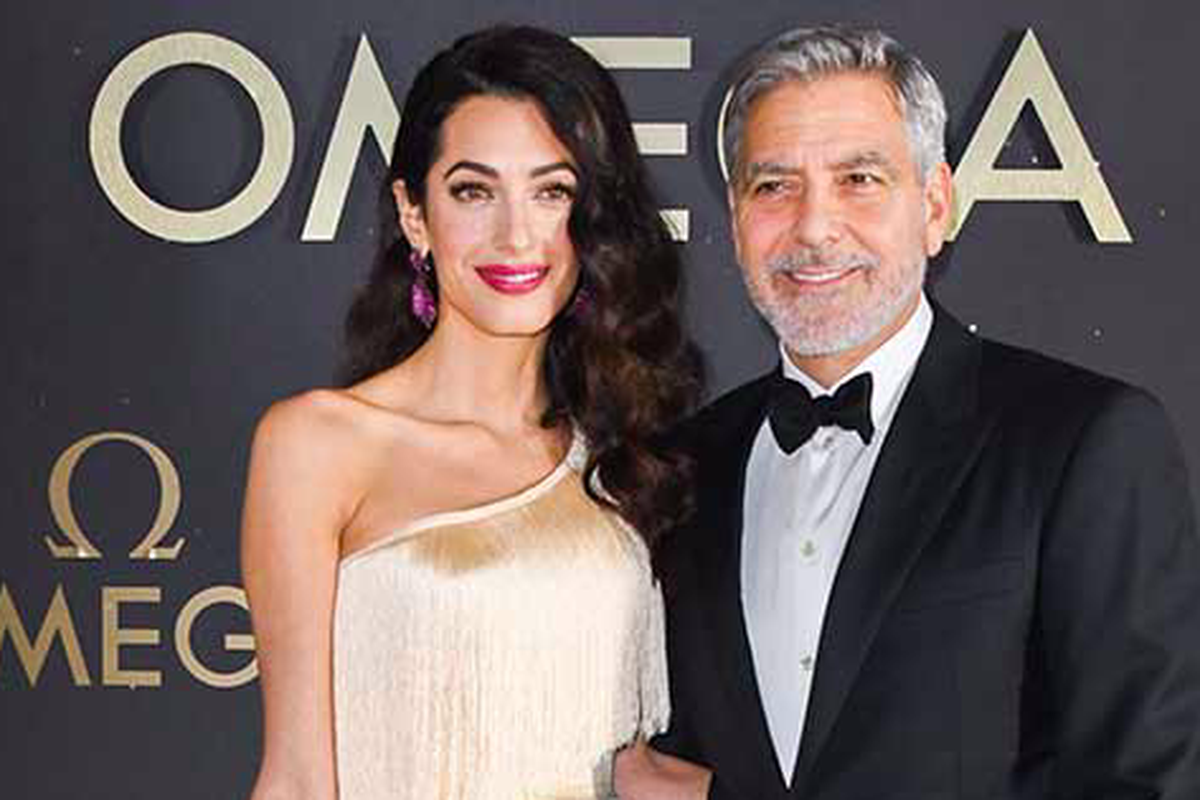Amal Clooney saat mendampingi suaminya, George Clooney.