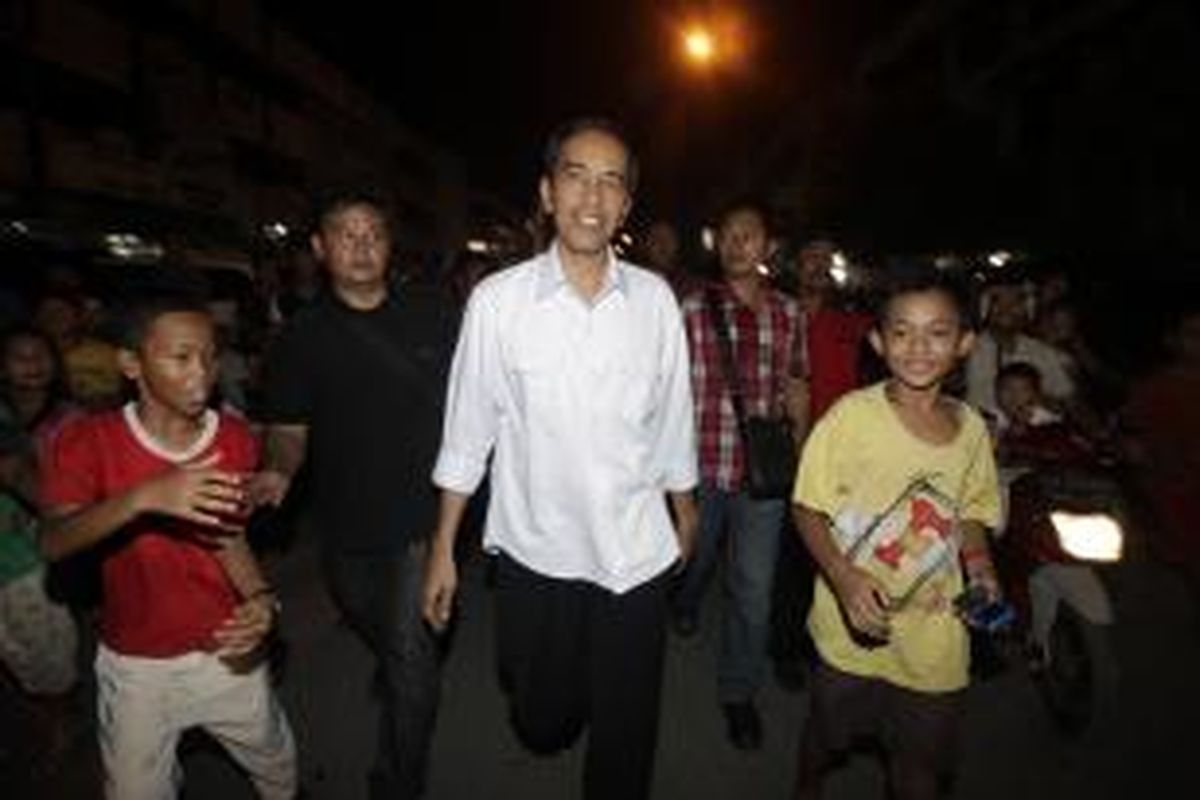 Calon Presiden dan juga Gubernur DKI Jakarta Joko Widodo (Jokowi) disambut warga saat hendak makan malam di kawasan Pasar Kangkung, Jalan Hasanudin, Teluk Betung, Bandar Lampung, Provinsi Lampung, Jumat (21/3/2014). Jokowi dijadwalkan akan menjadi juru kampanye Partai Demokrasi Indonesia Perjuangan di beberapa kota di Provinsi Lampung. KOMPAS IMAGES/RODERICK ADRIAN MOZES