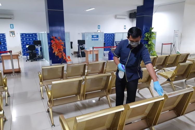 Seorang petugas tengah membersihkan fasilitas pengujian di Satpas SIM untuk mencegah penyebaran virus corona.