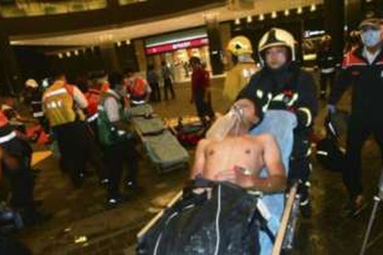 Petugas membantu seorang korban ledakan di sebuah kereta komuter di Taiwan, Kamis (7/7/2016) malam.