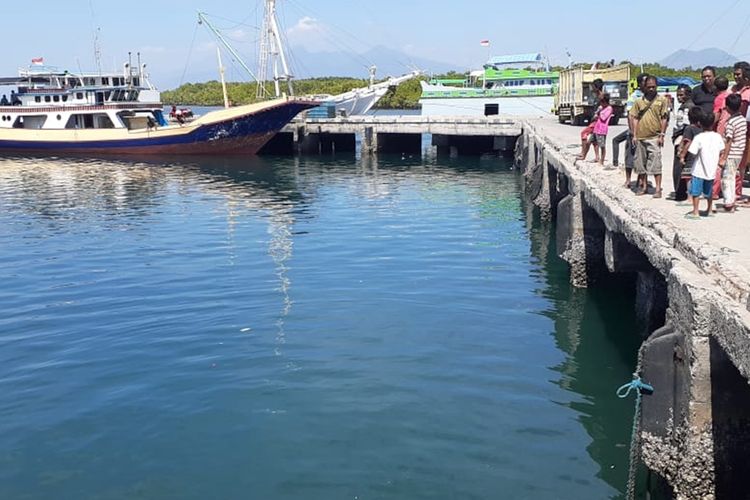 Warga setempat menyaksikan mobil pick up yang diceburkan ke laut oleh pemiliknya karena tak mampu bayar cicilan krredit di pelabuhan Wuring, Maumere, Kabupaten Sikka, NTT, Jumat (23/8/2019).