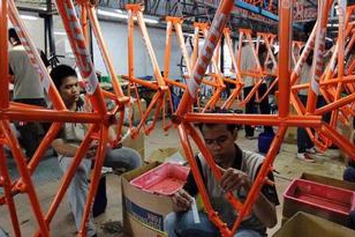Pekerja memasang label di kerangka sepeda merek SCOTT di pabrik sepeda PT Insera Sena di Desa Wadungasih, Bunduran, Sidoarjo, Jawa Timur, Selasa (22/5/2010). Tahun 2009, Insera telah memproduksi 500 ribu unit sepeda dan untuk tahun ini ditargetkan mencapai 600 ribu unit. Sebanyak 65 persen total produksi tersebut adalah sepeda merek SCOTT dan sejumlah merek lainnya yang diekspor untuk memenuhi pasar Eropa. Sedangkan untuk pasar lokal, pabrik ini membuat sepeda dengan merek di antaranya Polygon dan MUSTANG.