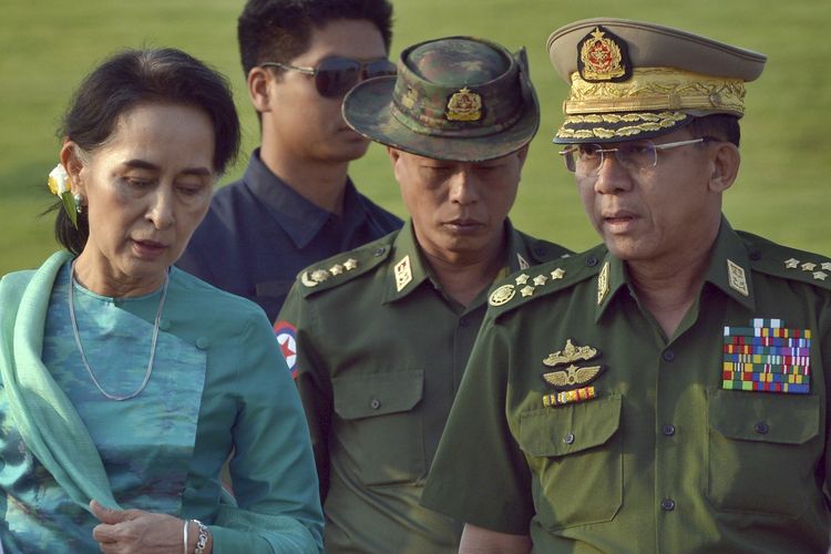 FILE - In this May 6, 2016, file photo, Aung San Suu Kyi, left, Myanmar's foreign minister, walks with senior General Min Aung Hlaing, right, Myanmar military's commander-in-chief, in Naypyitaw, Myanmar. Myanmar military television said Monday, Feb. 1, 2021 that the military was taking control of the country for one year, while reports said many of the country's senior politicians including Suu Kyi had been detained. (AP Photo/Aung Shine Oo, File)
