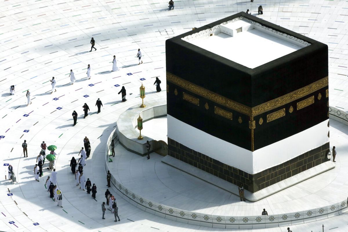 Para jemaah mengelilingi Ka'bah di Masjidil Haram, dengan mengenakan masker dan menjaga jarak sosial, pada Sabtu (17/7/2021).  Selama dua tahun berrturut-turut, ibadah haji dibatasi dengan ketat karena virus corona.