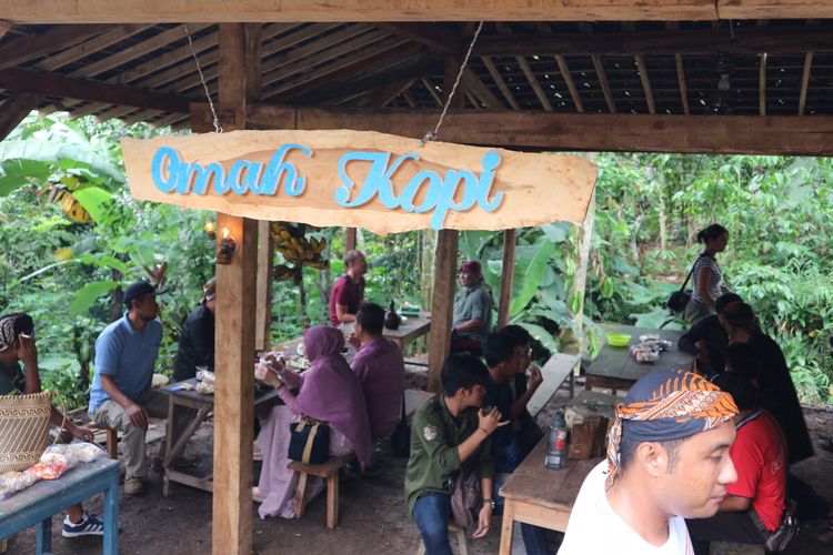 Tourists enjoying local coffee at a traditional village in Jombang Regency, East Java. 
