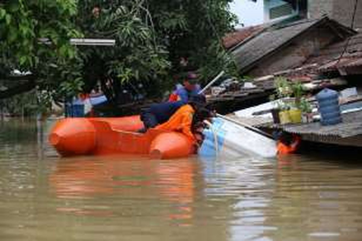 Sejumlah petugas membantu evakuasi warga yang terkena banjir di Perumahan Total Persada Kota Tangerang, Senin (14/11/2016). Banjir di Kota Tangerang disebabkan oleh luapan dari beberapa kali dan tersumbatnya drainase di sejumlah titik.