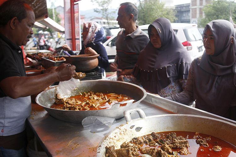 Bang Nasir bersama sejumlah pekerjanya sedang melayani pembeli kari pada sore hari menjelang waktu berbuka, Rabu (23/05/18). Warung  Bebek Bang Nasir yang terkenal ini beralamat di Pasar Lambaro, Kabupaten Aceh Besar.