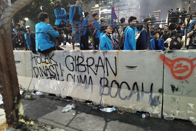 Coretan oleh mahasiswa di pembatas beton saat demo di Jalan Medan Merdeka Barat, Gambir, Jakarta Pusat, Jumat (20/10/2023)