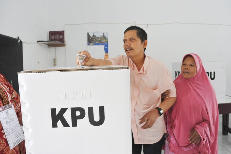 Penyandang tunanetra, Saiful Iman (46) memasukkan surat suara ke dalam kotak suara pada Pemilihan Gubernur dan Wakil Gubernur Sumatra Utara di TPS 16 di Kantor DPD Persatuan Tuna Netra Indonesia (Pertuni) Sumut, Jalan Sampul, Medan, Rabu (27/6/2018). Di TPS 16 ini penyandang tuna netra belum menggunakan surat suara braile, sehingga pemilih harus dibantu oleh relawan TPS atau keluarganya. 