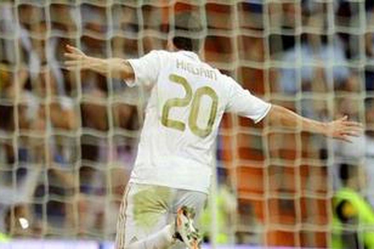 Striker Real Madrid, Gonzalo Higuain, meluapkan kegembiraannya setelah membobol gawang Real Betis, pada pertandingan Liga BBVA, Sabtu (15/10/2011). Higuain akhirnya mencetak hat-trick dan Madrid menang 4-1.