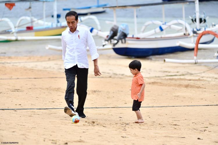 Presiden Joko Widodo bermain bola bersama cucunya, Jan Ethes, di Pantai Sanur Bali, tepatnya di belakang hotel tempatnya dan keluarga menginap, Jumat (14/6/2019), dalam kunjungan kerja ke Provinsi Bali.