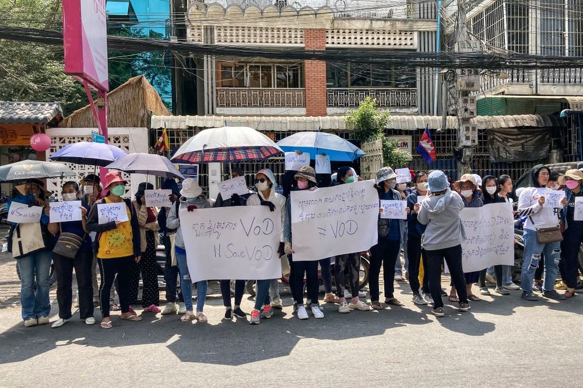 Supporters of online media outlet Voice of Democracy (VOD) hold placards in front of VOD office in Phnom Penh on February 13, 2023, after Cambodian Prime Minister said VOD would have its operating licence revoked. Cambodia's strongman leader late on February 12 ordered the shutdown of one of the country's few remaining local independent media outlets after taking issue with a news report about his son.