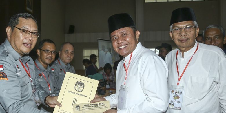 Pasangan bakal calon Gubernur dan Wakil Gubernur Sumsel Herman Deru (kedua kanan)-Mawardi Yahya (kanan) menerima berkas pendaftaran dari Ketua KPU Sumsel Aspahani (kiri), di kantor KPU Sumsel, Palembang, Sumatra Selatan, Selasa (9/1). Herman Deru-Mawardi Yahya yang diusung Partai NasDem, Hanura dan PAN akan maju sebagai pasangan bakal calon Gubernur dan Wakil Gubernur  Provinsi Sumsel pada Pilkada 2018. ANTARA FOTO/Nova Wahyudi/kye/18