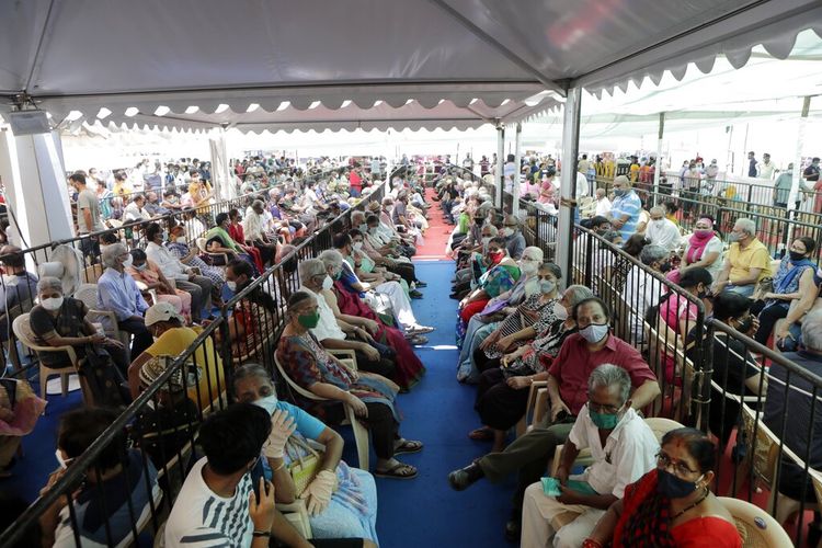 Orang-orang menunggu untuk menerima vaksin COVID-19 di luar pusat vaksinasi Di Mumbai, India, Sabtu, 24 April 2021. 