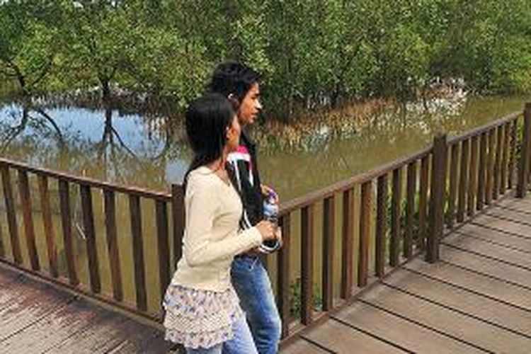 Pengunjung menikmati Hutan Wisata Mangrove Wonorejo, Surabaya, Senin (9/2/2015). Pemerintah Kota Surabaya bersama warga secara aktif melestarikan hutan mangrove sebagai sabuk hijau. Dari Mangrove itu oleh warga dijadikan bahan baku produk makanan dan batik.