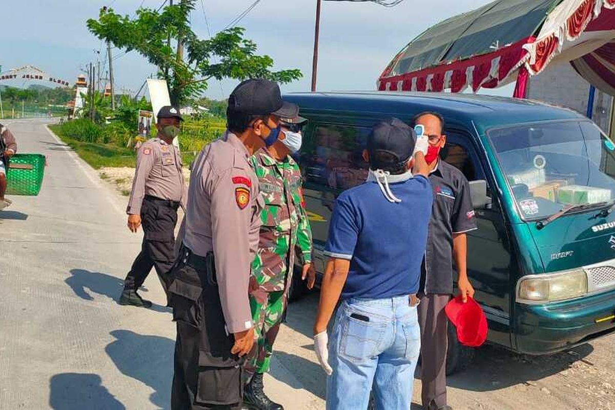 Petugas gabungan memeriksa kendaraan yang hendak memasuki wilayah Kabupaten Blora, Jawa Tengah, Minggu (26/4/2020).