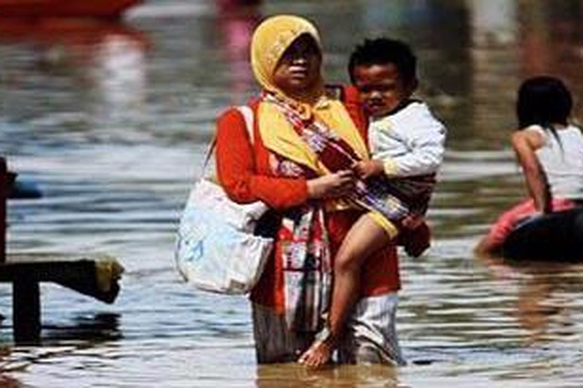Warga menyeberangi genangan banjir yang merendam Jalan Anggadiredja, Baleendah, Kabupaten Bandung, Jawa Barat, akibat luapan Sungai Citarum, Rabu (27/4). Ribuan rumah warga di Kecamatan Dayeuhkolot dan Baleendah terendam banjir setelah sehari sebelumnya terjadi hujan yang cukup deras di daerah hulu sungai tersebut.