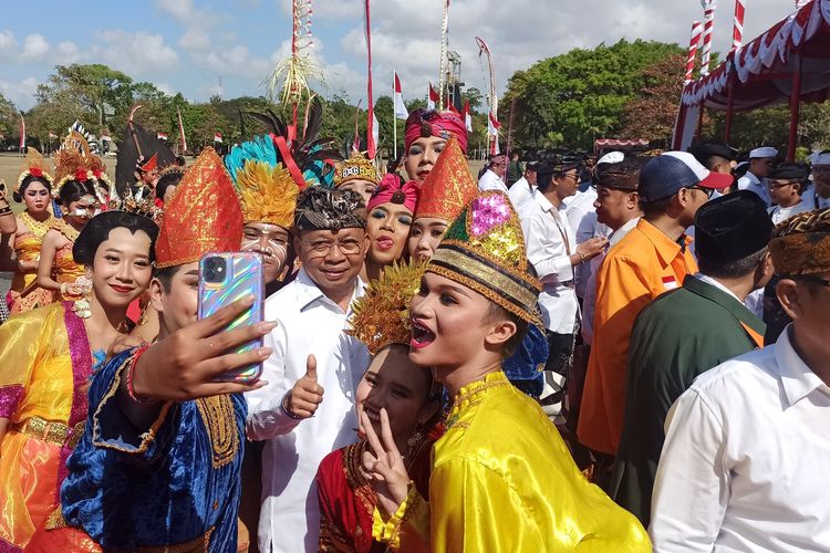 Ketua DPD PDI Perjuangan Bali I Wayan Koster berfoto bersama para penari dalam acara perayaan HUT Provinsi Bali ke 66, di Lapangan Niti Mandala Renon, Kota Denpasar, Bali, Rabu (14/8/2024). Kompas.com/ Yohanes Valdi Seriang Ginta