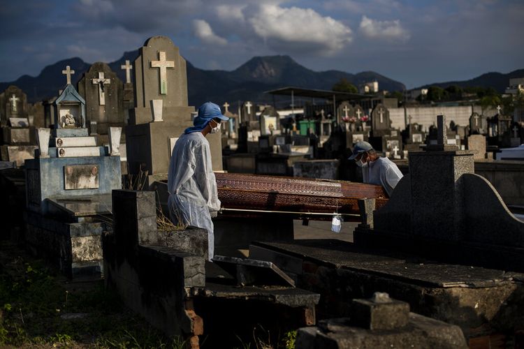 Cemetery workers carry the coffin that contains the remains of 89-year-old Irodina Pinto Ribeiro, who died from COVID-19 related complications, at the Inhauma cemetery in Rio de Janeiro, Brazil, Friday, June 18, 2021. Brazil is approaching an official COVID-19 death toll of 500,000 ? second-highest in the world. (AP Photo/Bruna Prado)