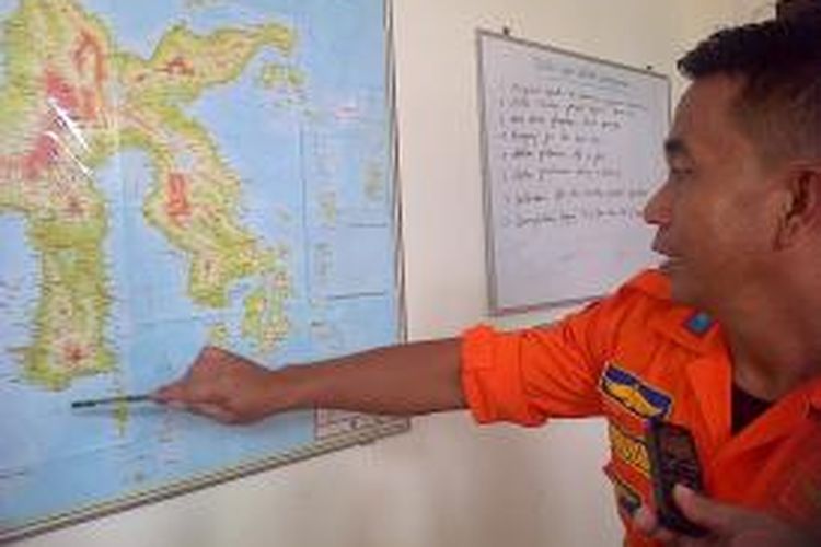 Kepala Kantor SAR Kendari, Amiruddin menunjukkan peta lokasi pencarian korban dan serpihan pesawat Air Asian di Pulau Kabaena
