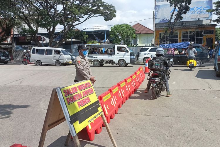 Petugas menutup akses jalan menuju Kawasan Objek Wisata Pantai Anyer di Jalan Lingkar Selatan Cibeber Cilegon. Sabtu (13/4/2024). Penutupan dilakukan karena Pantai Anyer sudah dipadati wisatawan menghabis waktui libur lebaran.