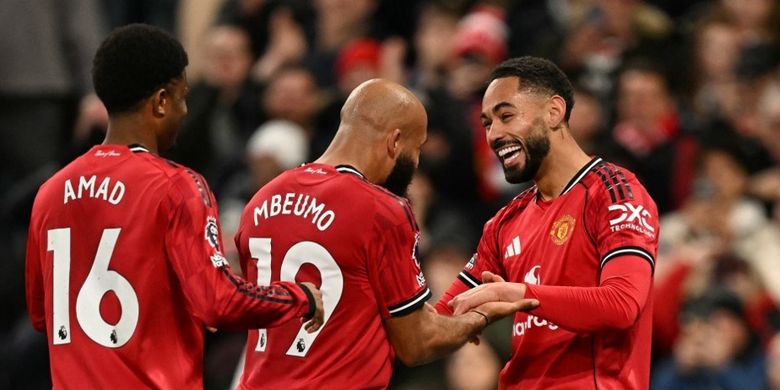 Penyerang Manchester United Matheus Cunha merayakan gol pembuka bersama Bryan Mbeumo dan Amad Diallo pada laga Liga Inggris antara Manchester United dan Brighton dan Hove Albion di Old Trafford di Manchester, Inggris barat laut, pada tanggal 25 Oktober 2025.