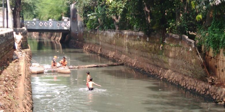 Dua bocah Haikal dan Aldi saat bermain dan berenang di aliran Kali Mampang, Jakarta Selatan, Jumat (6/5/2016)