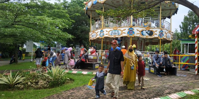 Sejumlah pengunjung di Taman Legenda Keong Mas, Taman Mini Indonesia Indah, pada hari pertama Idul Fitri, Senin (2/5/2022).