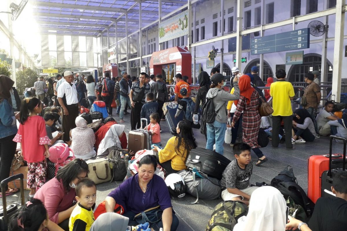Ratusan calon penumpang kereta api terpaksa duduk secara lesehan di sepanjang koridor Stasiun Pasar Senen, Jakarta Pusat, Sabtu (9/6/2018).