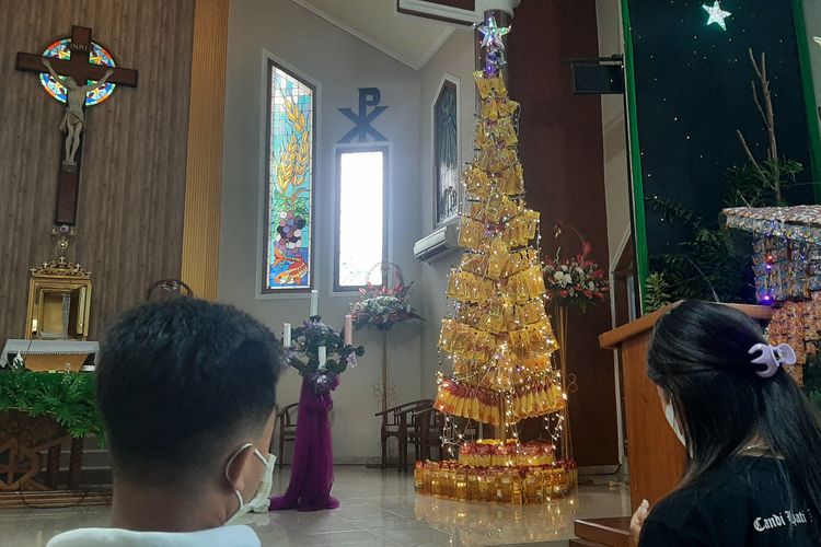 Petugas Misa Natal Gereja Katolik Maria Ratu Damai, Kabupaten Banyuwangi, Jawa Timur, berlatih penyelenggaraan misa di depan pohon Natal yang terbuat dari minyak goreng kemasan, Kamis (23/12/2021).