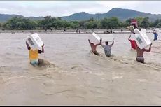 Warga NTT Terobos Banjir Sambil Memikul Puluhan Kotak Suara