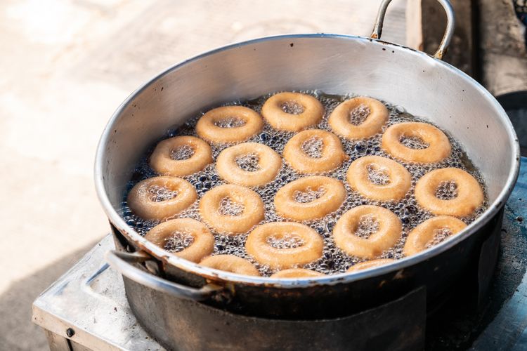 Ilustrasi donat yang sedang digoreng.