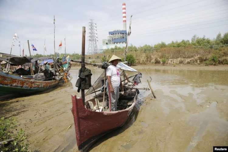 Seorang nelayan berdiri di dekat kapalnya di sungai dekat pembangkit listrik di Cirebon, 18 Oktober 2014. (Foto: Ilustrasi/Reuters)