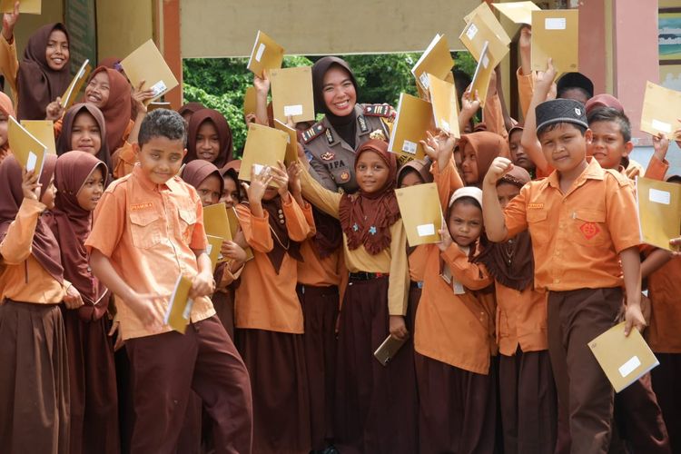 Satlantas Polres Aceh Besar AKP Vifa membagikan buku kepada anak-anak sekolah dasar di pulua terluar Kabupaten Aceh Besar.