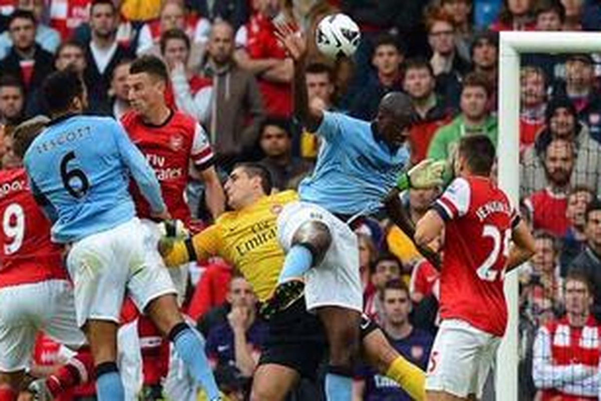 Bek Manchester City, Joleon Lescott (kedua dari kiri), menyundul bola yang berujung gol ke gawang Arsenal, pada laga Premier League, di Etihad Stadium, Minggu (23/9/2012).
