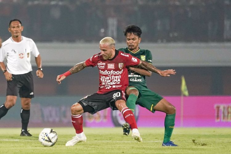 Gelandang bertahan Persebaya Muhammad Hidayat berusaha menghentikan aksi pemain Bali United Paulo Sergio Moreira Goncalves. Persebaya takluk 1-2 pada laga perdana Liga 1 2019 melawan Bali United di Stadion Kapten I Wayan Dipta, Kamis (16/5/2019) malam.