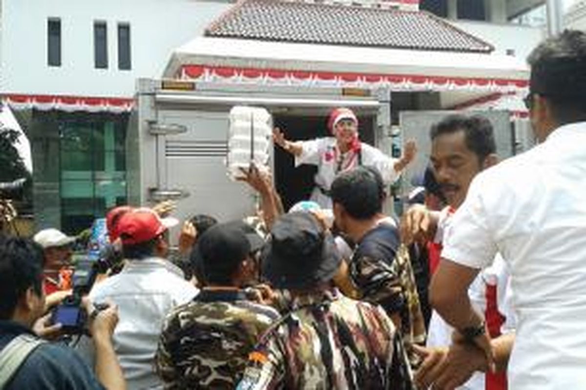 Pendukung Prabowo-Hatta mengambil jatah makan siang dari koordinator konsumsi di halaman parkir gedung Kementerian Koordinator Bidang Perekonomian, Gambir, Jakarta Pusat, Selasa (19/8/2014).