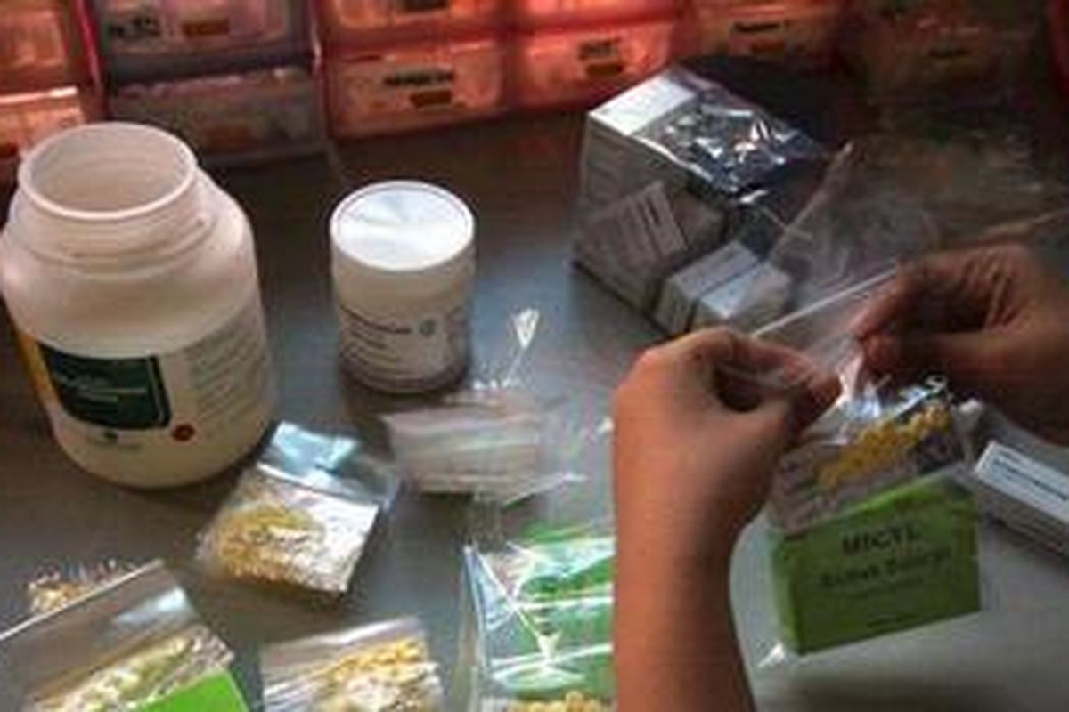 Ilustrasi: Apoteker di ruang obat Puskesmas Tanjung Duren Selatan, Jakarta, mempersiapkan pelayanan gratis obat gatal. 