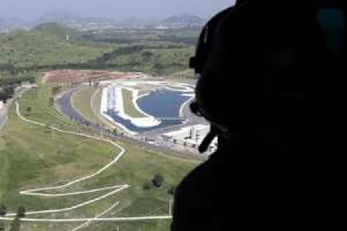 Seorang tentara Brasil mengintip  dari sebuah helikopter militer yang sedang ambil bagian dalam pelatihan keamanan menjelang Olimpiade di Rio  de Janeiro, Agustus 2016. Gambar ini diambil pada 6 April 2016.